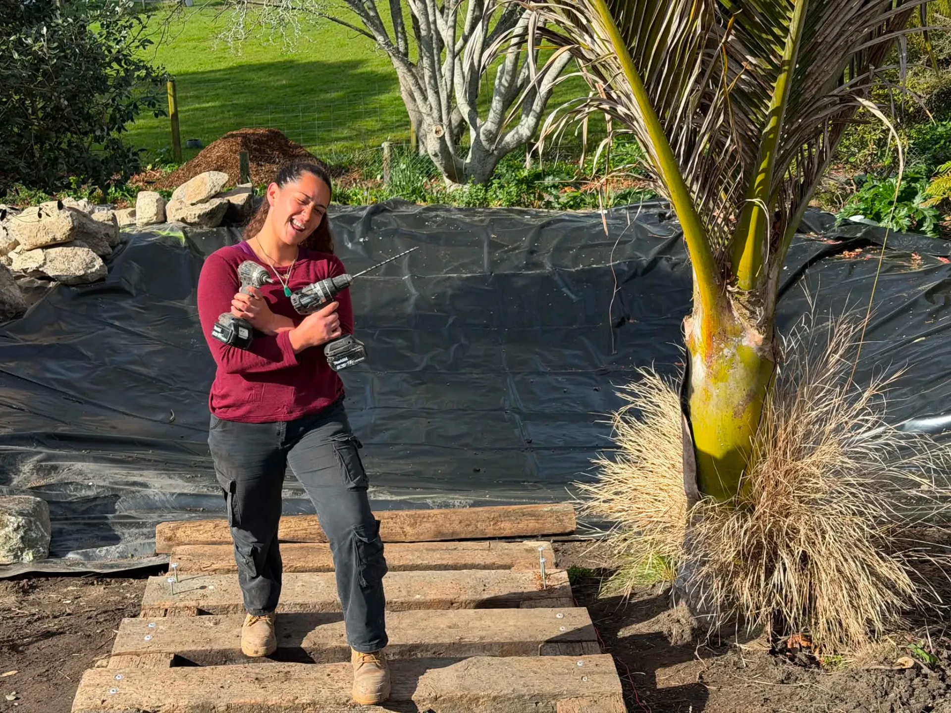 Jordyn from Down 2 Earth building timber steps with a drill