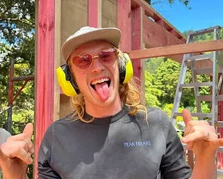 Blu from Down 2 Earth framing a structure on-site